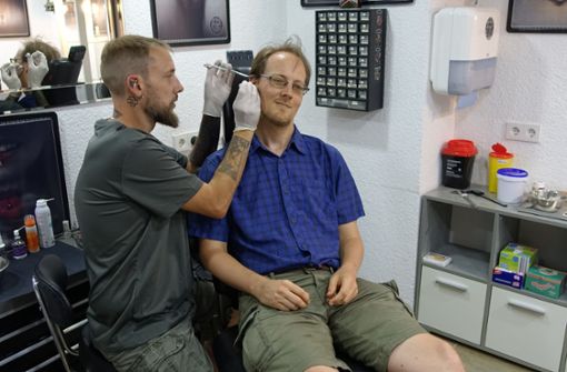Tätowierer Michael Horler sticht in den Akupunkturpunkt im Ohr. Foto: Kühnl