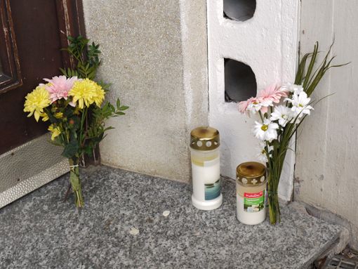 Blumen und Kerzen haben die Winterlinger am Tag nach dem mutmaßlichen Mord vor der Tür des Hauses abgelegt, in dem sich das Familiendrama ereignet hat.  Foto: Eyrich