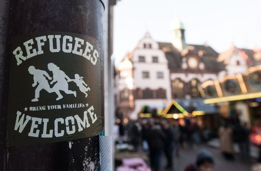 Ein Aufkleber mit der Aufschrift „Refugees welcome“ hängt in der Innenstadt von Freiburg am Rathausplatz. Die politische Diskussion über unbegleitete minderjährige Flüchtlinge kocht nach dem Mord an der Studentin hoch. Foto: dpa